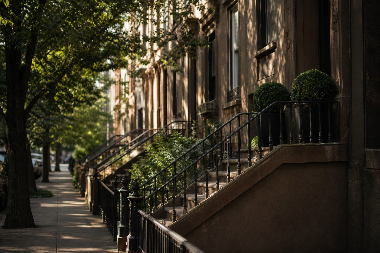 A brownstone stoop on a quiet residential street